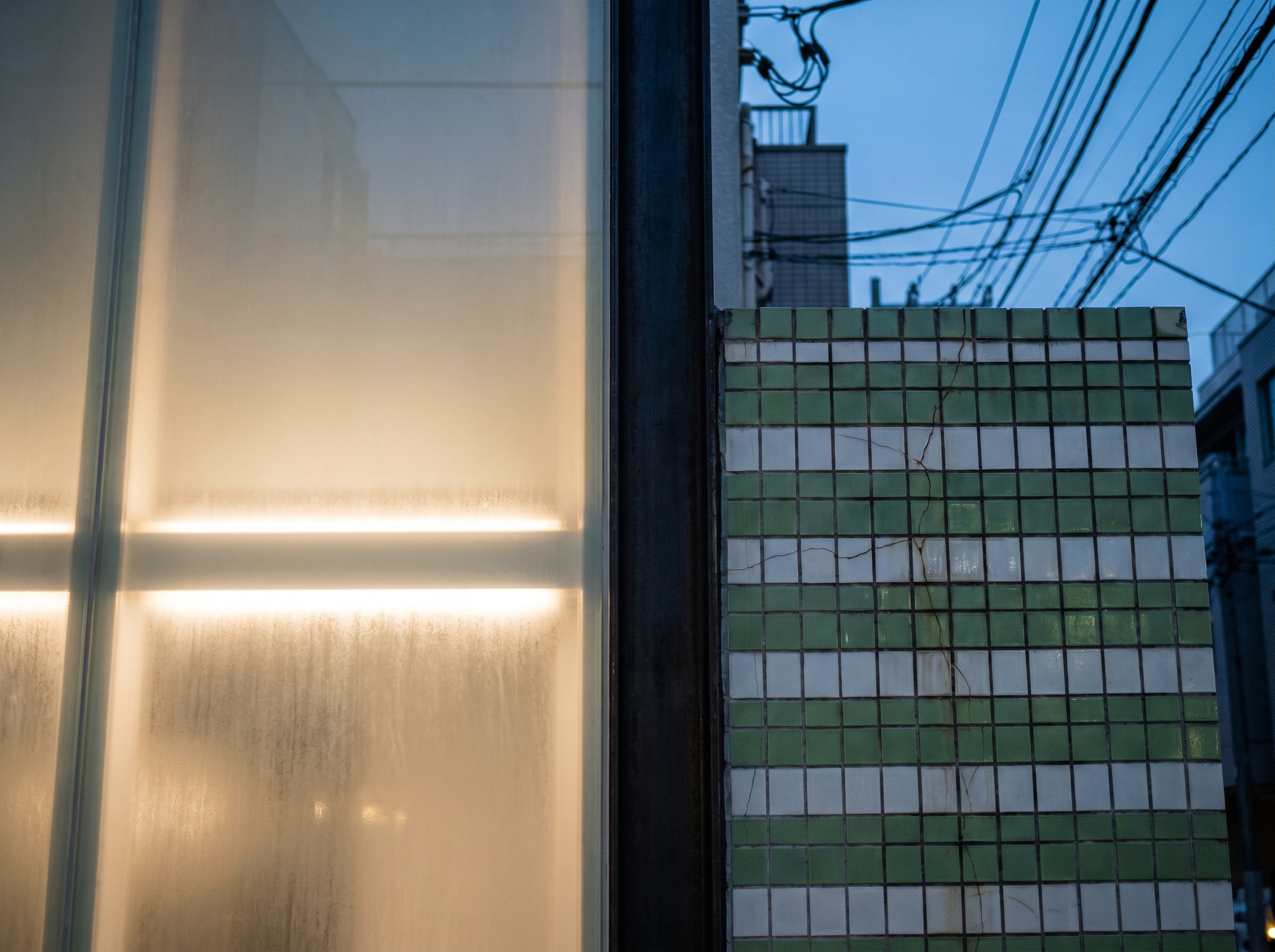 Three centimeters of blackened steel between old tile and new glass